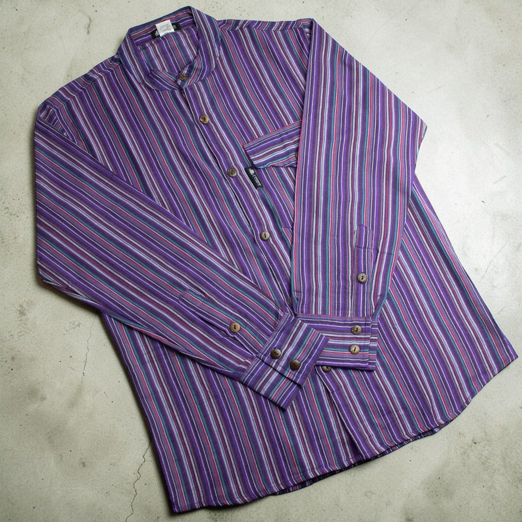 Front view of the Nomad Sari Grandad Shirt featuring bold vertical purple and black stripes on breathable cotton fabric.